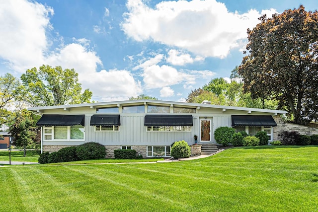 347 Park Dr, Palatine, IL 60067 - mid-century inspired home with board and batten siding, a front yard, and stone siding
