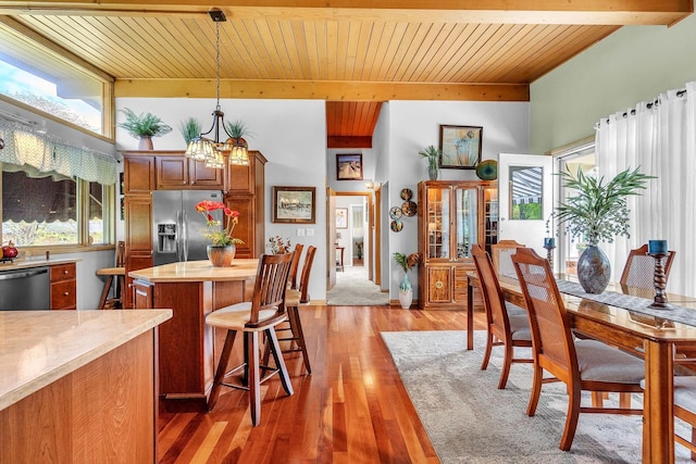347 Park Dr, Palatine, IL 60067 - kitchen featuring stainless steel appliances, wooden ceiling with exposed beams, light countertops, plenty of natural light, and a kitchen island