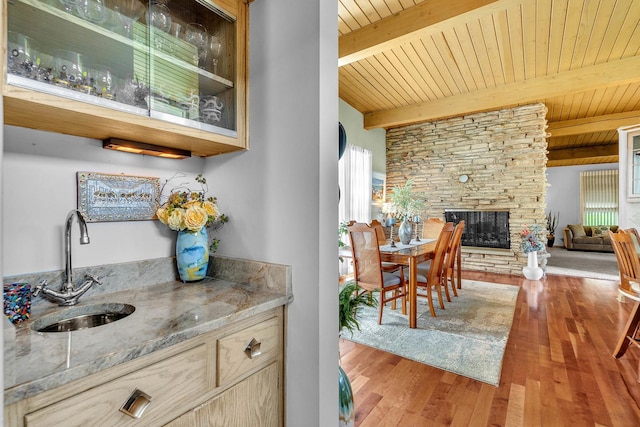 347 Park Dr, Palatine, IL 60067 - indoor wet bar with wooden ceiling with exposed beams, wood finished floors, and a stone fireplace