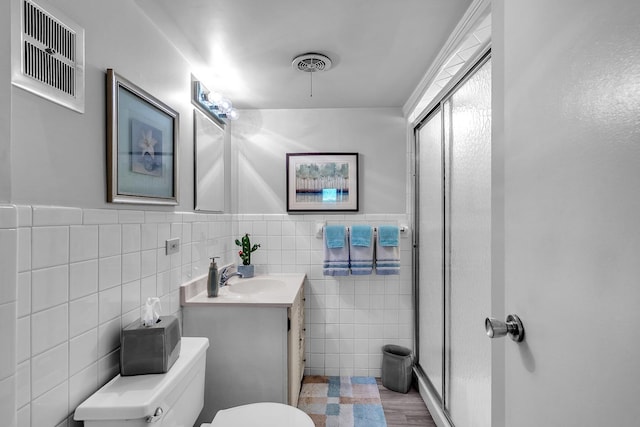 347 Park Dr, Palatine, IL 60067 - full bath with toilet, a stall shower, tile walls, vanity, and wainscoting
