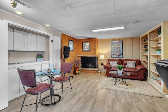 347 Park Dr, Palatine, IL 60067 - living room with light wood-style flooring and a brick fireplace