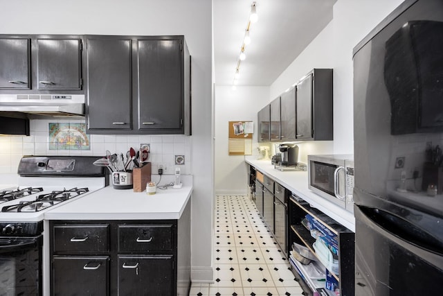 5000 S Cornell Ave Unit 21B, Chicago, IL 60615 - kitchen featuring freestanding refrigerator, gas range, under cabinet range hood, stainless steel microwave, and baseboards