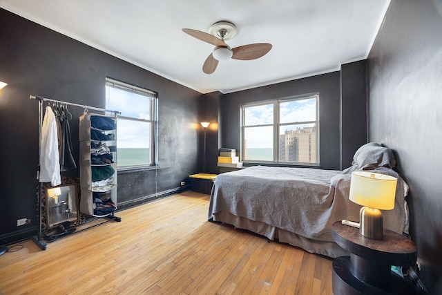 5000 S Cornell Ave Unit 21B, Chicago, IL 60615 - bedroom with hardwood / wood-style flooring, multiple windows, ornamental molding, and ceiling fan