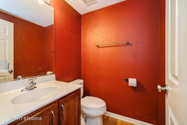 1098 N Claremont Dr Unit 1, Palatine, IL 60074 - half bath featuring toilet, vanity, wood finished floors, and baseboards