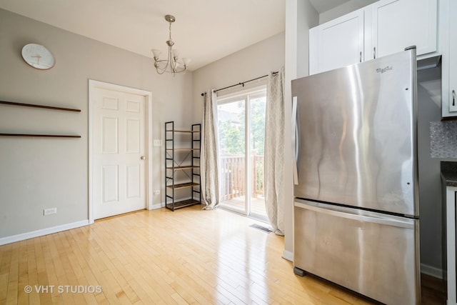 1098 N Claremont Dr Unit 1, Palatine, IL 60074 - kitchen with freestanding refrigerator, a chandelier, light wood-type flooring, baseboards, and white cabinetry