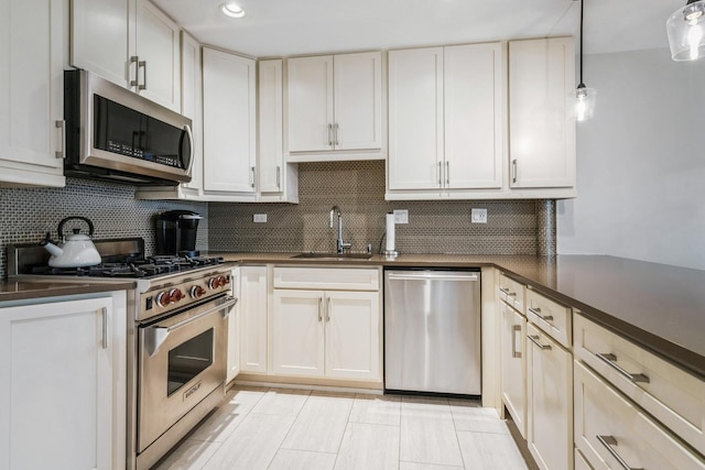 1063 W Busse Hwy, Park Ridge, IL 60068 - kitchen with appliances with stainless steel finishes, a sink, dark countertops, decorative backsplash, and pendant lighting