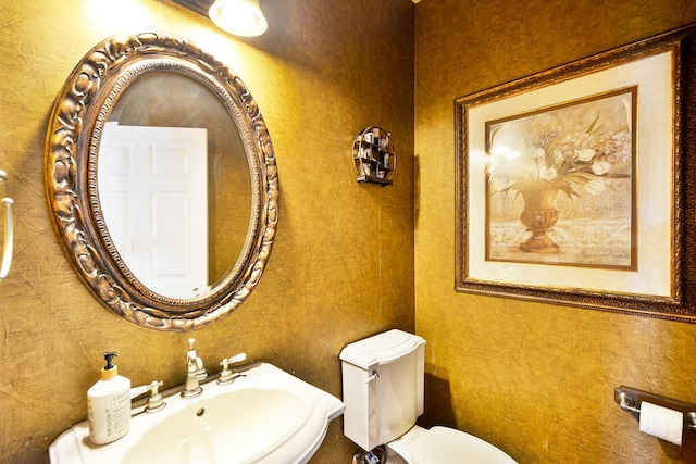 half bath featuring a sink and toilet