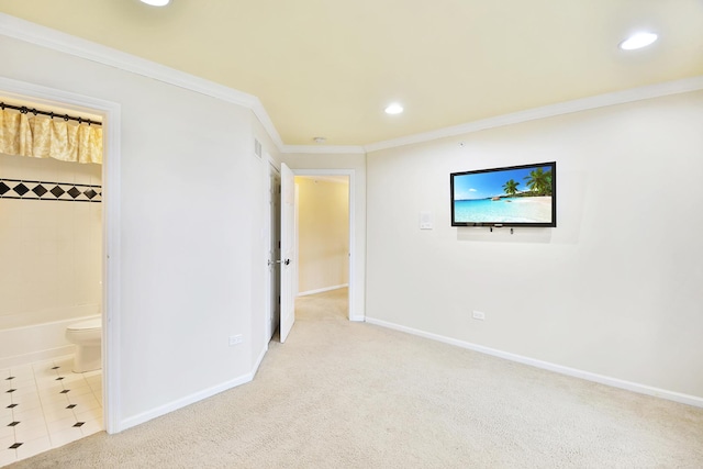 unfurnished bedroom with recessed lighting, crown molding, baseboards, carpet floors, and ensuite bath
