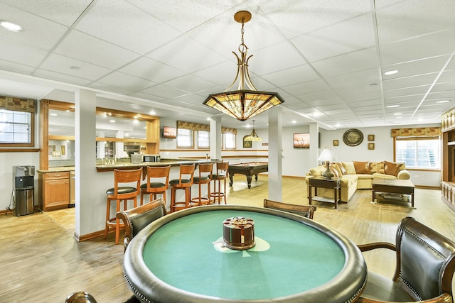 recreation room featuring light wood-style floors, a paneled ceiling, billiards, and baseboards