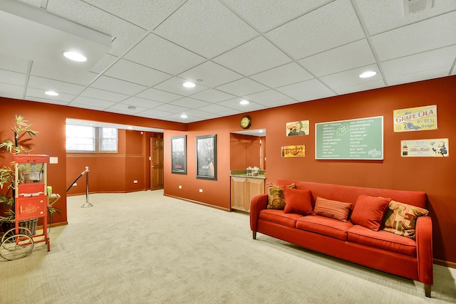 living area featuring carpet floors, baseboards, a paneled ceiling, and recessed lighting