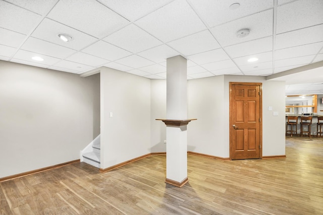 basement with wood finished floors, baseboards, stairway, a drop ceiling, and recessed lighting