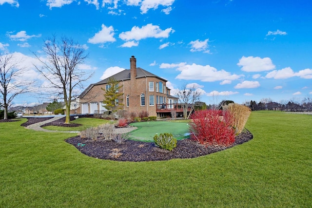 view of grassy yard featuring a putting green and an attached garage