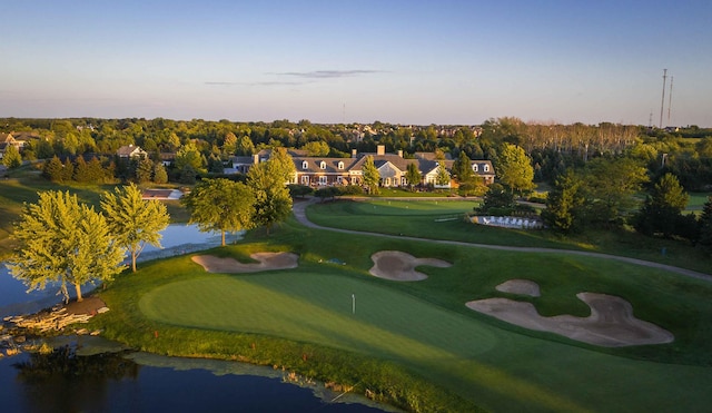 view of community with view of golf course, a putting green, and a water view