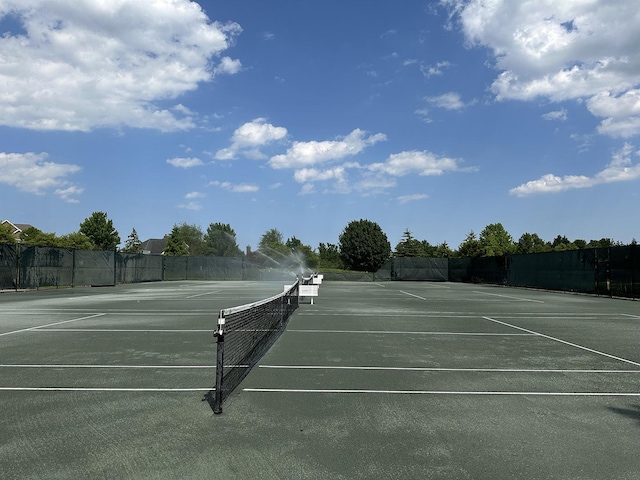 view of tennis court with fence