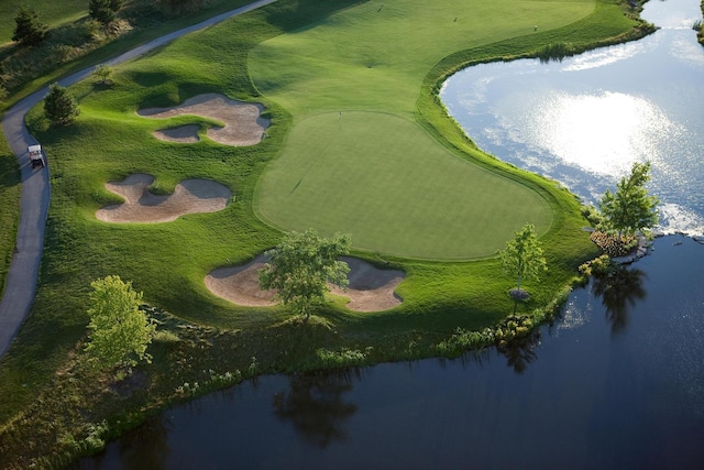 view of property location featuring a nearby body of water and a local golf course