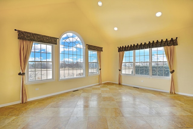 empty room featuring healthy amount of natural light, high vaulted ceiling, baseboards, and recessed lighting