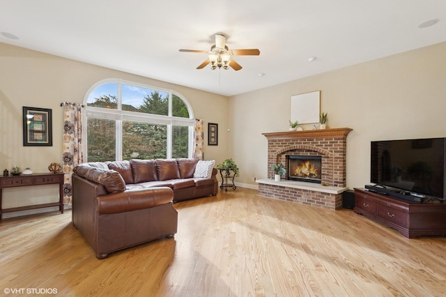 25738 W Sunnymere Dr, Plainfield, IL 60585 - living area featuring a ceiling fan, light wood-style flooring, a fireplace, and baseboards