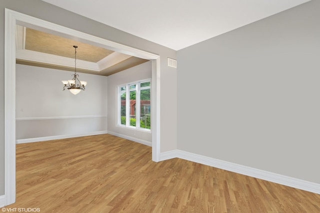 25738 W Sunnymere Dr, Plainfield, IL 60585 - unfurnished room with light wood finished floors, baseboards, a chandelier, and a tray ceiling