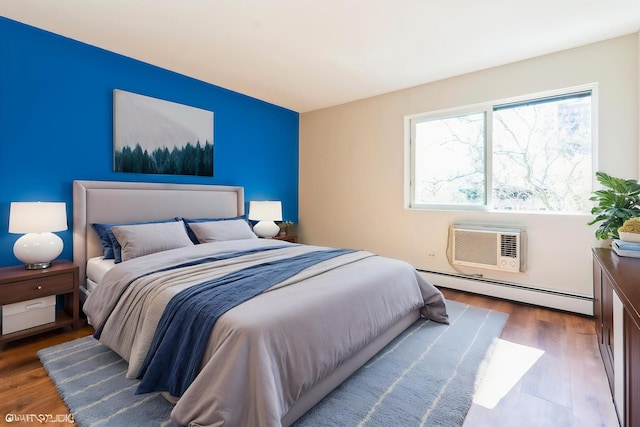 401 W Webster Ave Unit 509, Chicago, IL 60614 - bedroom with a baseboard heating unit, wood finished floors, and a wall mounted air conditioner