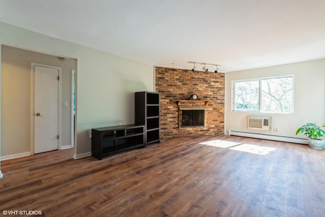401 W Webster Ave Unit 509, Chicago, IL 60614 - unfurnished living room featuring a baseboard radiator, wood finished floors, rail lighting, and a fireplace