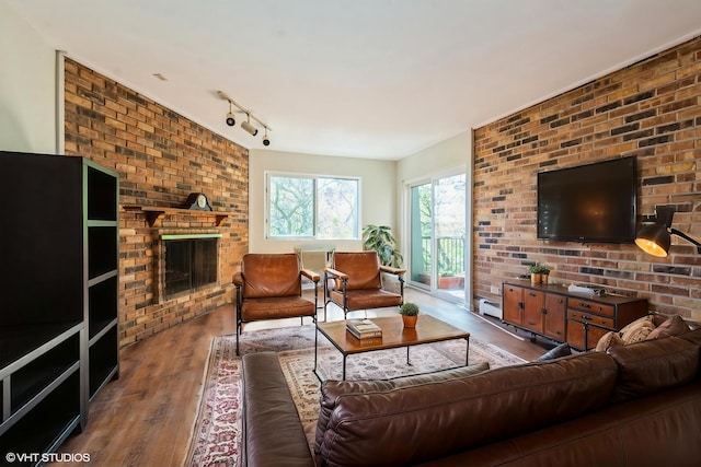 401 W Webster Ave Unit 509, Chicago, IL 60614 - living room featuring wood finished floors, a brick fireplace, and rail lighting