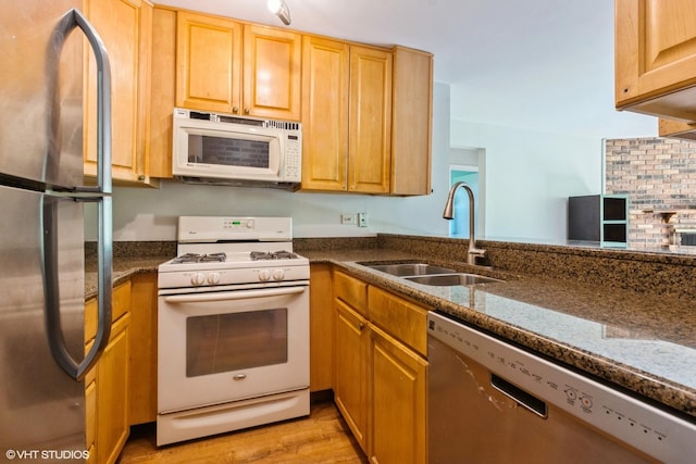 401 W Webster Ave Unit 509, Chicago, IL 60614 - kitchen with stainless steel appliances, a sink, light wood finished floors, and dark stone countertops