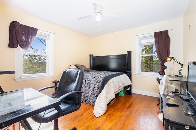 9821 S University Ave, Chicago, IL 60628 - bedroom featuring wood-type flooring, baseboards, an office area, and a ceiling fan