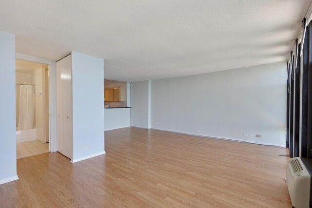 6700 S S Shore Dr Unit 19K, Chicago, IL 60649 - unfurnished living room with light wood-style flooring and baseboards