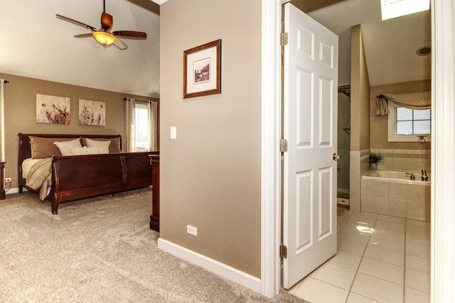 25451 Regent Blvd, Shorewood, IL 60404 - bedroom featuring multiple windows, light tile patterned floors, baseboards, ensuite bathroom, and vaulted ceiling