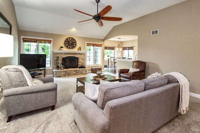 25451 Regent Blvd, Shorewood, IL 60404 - living area with carpet floors, vaulted ceiling, a ceiling fan, a glass covered fireplace, and baseboards