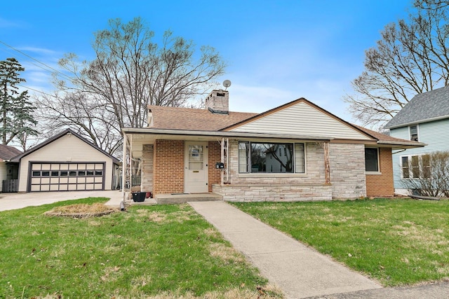 807 S Main St, Belvidere, IL 61008 - view of front of house with a detached garage, a chimney, a front lawn, a shingled roof, and stone siding