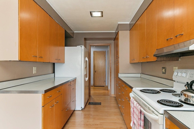 807 S Main St, Belvidere, IL 61008 - kitchen with white appliances, under cabinet range hood, light wood-style floors, crown molding, and brown cabinetry