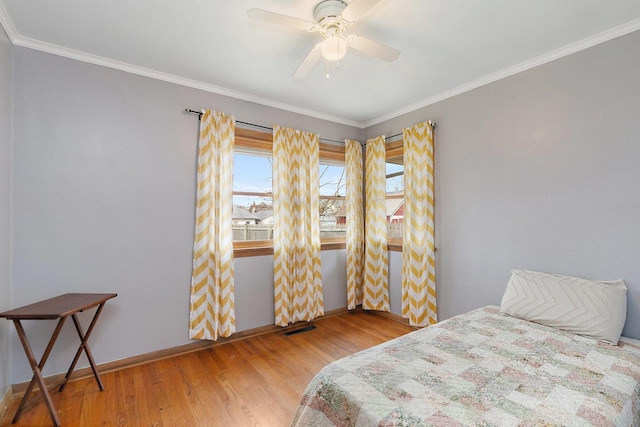 807 S Main St, Belvidere, IL 61008 - bedroom featuring wood finished floors, crown molding, baseboards, and ceiling fan