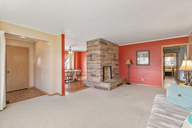 807 S Main St, Belvidere, IL 61008 - living room with carpet floors, ornamental molding, a stone fireplace, and baseboards