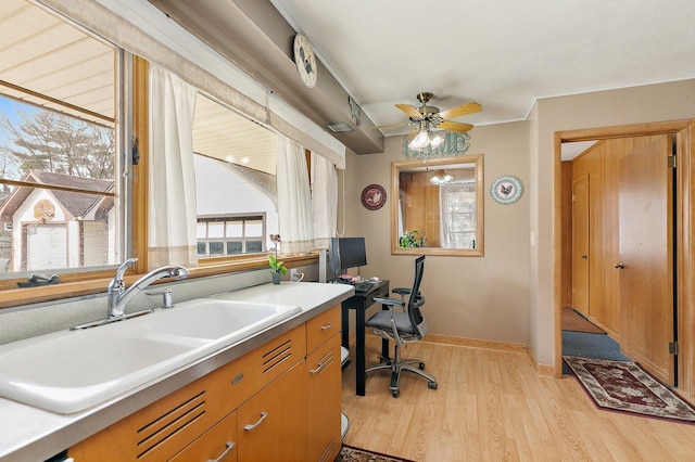 807 S Main St, Belvidere, IL 61008 - office area with a sink, light wood-style floors, ceiling fan, and baseboards