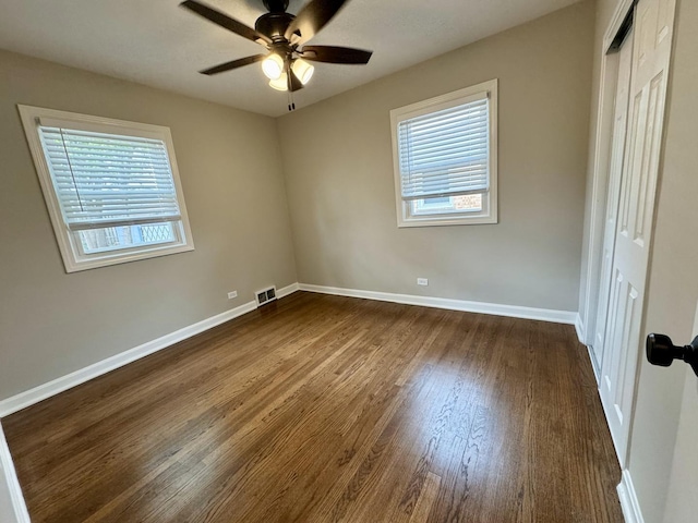 2122 Mandel Ave, Westchester, IL 60154 - unfurnished bedroom with dark wood finished floors, baseboards, a closet, and ceiling fan