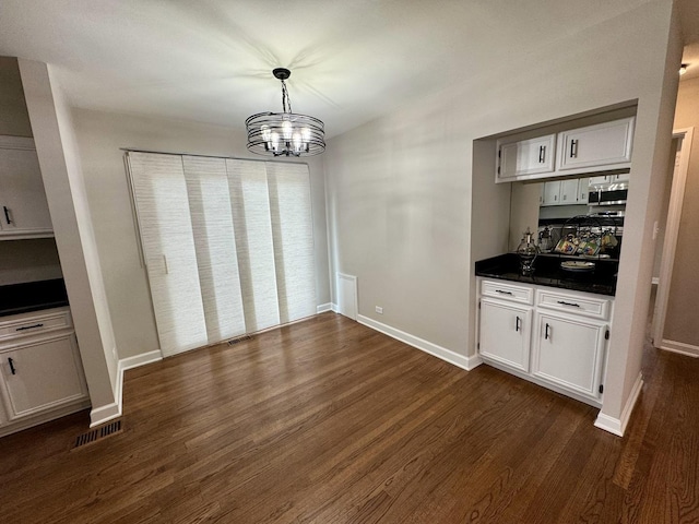 2122 Mandel Ave, Westchester, IL 60154 - unfurnished dining area with dark wood-style flooring, a chandelier, and baseboards