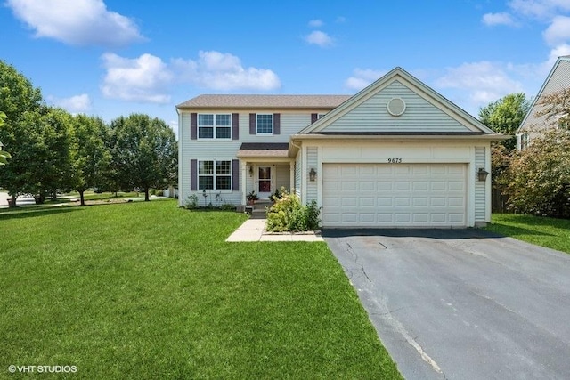 9675 Newton Rd, Huntley, IL 60142 - traditional-style home featuring driveway, an attached garage, and a front lawn