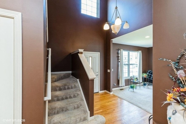 9675 Newton Rd, Huntley, IL 60142 - entrance foyer with stairway, wood finished floors, a high ceiling, and a chandelier