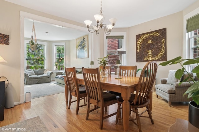 3624 N Leavitt St, Chicago, IL 60618 - dining room featuring healthy amount of natural light, light wood-type flooring, and a chandelier