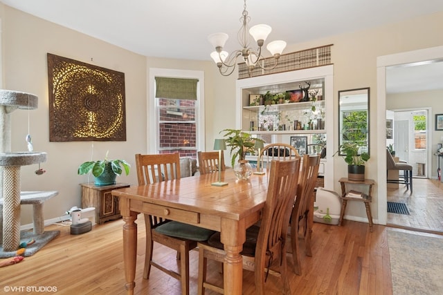 3624 N Leavitt St, Chicago, IL 60618 - dining area with light wood-style flooring and a chandelier