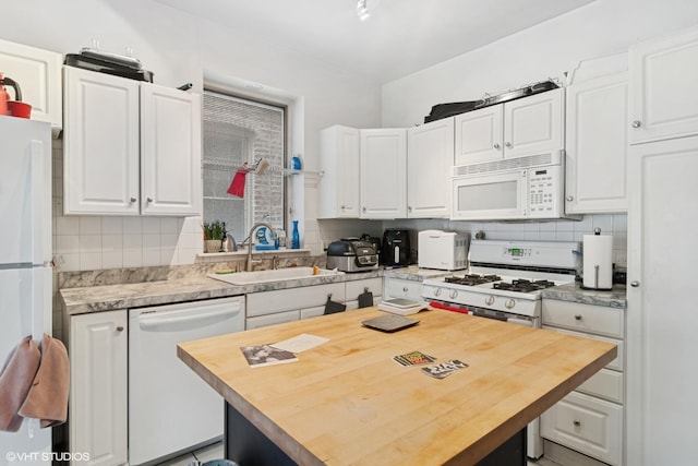 3624 N Leavitt St, Chicago, IL 60618 - kitchen with white appliances, a sink, white cabinetry, and backsplash