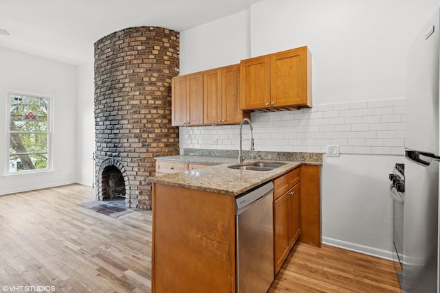 2424 N Seminary Ave, Chicago, IL 60614 - kitchen featuring a sink, stainless steel dishwasher, light stone counters, light wood finished floors, and brown cabinets