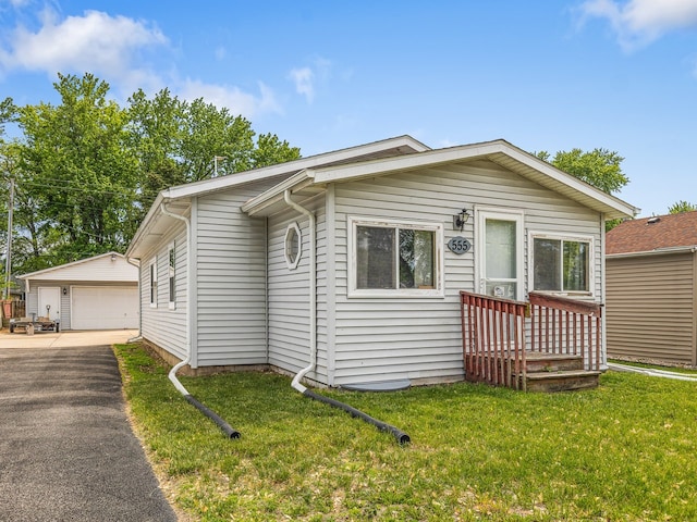 555 Marquette Rd, Machesney Park, IL 61115 - view of front of home with a garage, an outdoor structure, and a front lawn