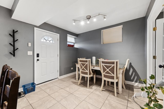 dining area featuring light tile patterned flooring and baseboards