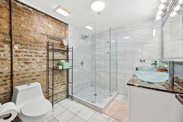 full bath featuring tiled shower, toilet, vanity, tile patterned flooring, and brick wall