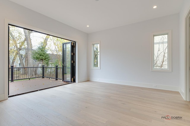 unfurnished room with light wood finished floors, baseboards, and recessed lighting