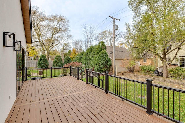 wooden terrace featuring a lawn