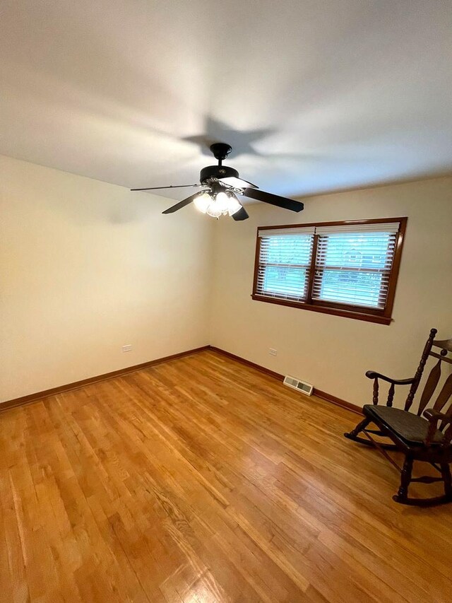 5941 W 99th St, Oak Lawn, IL 60453 - unfurnished room featuring light wood-style flooring, baseboards, and ceiling fan