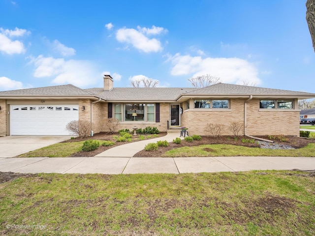 ranch-style home featuring brick siding, a garage, concrete driveway, and a chimney